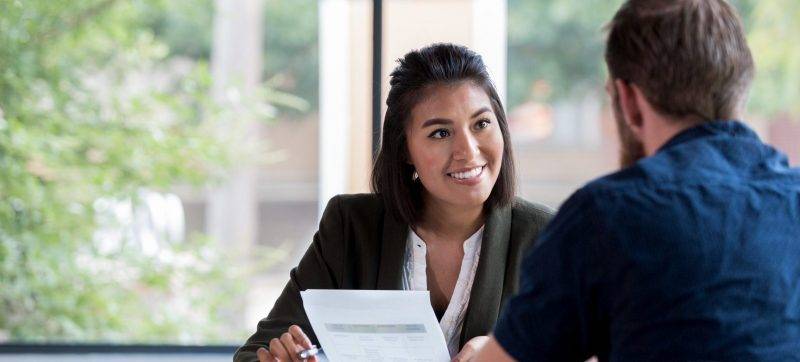 Cheerful businesswoman meets with client