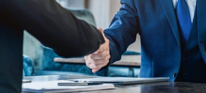 Handshaking between business partners after making a deal indoors
