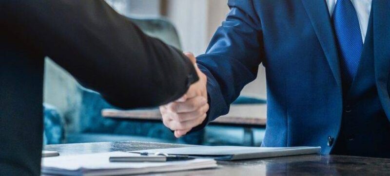 Handshaking between business partners after making a deal indoors